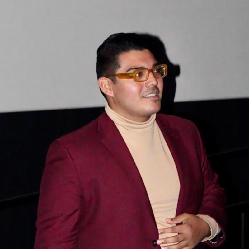 Salomón Flamenco in a burgundy blazer and tan turtleneck